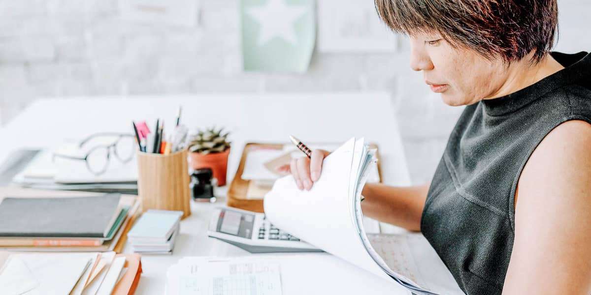 woman with papers on desk
